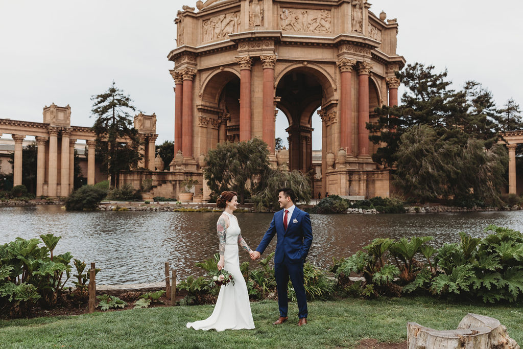 newly eloped couple holding hands at the palace of fine arts in san francisco