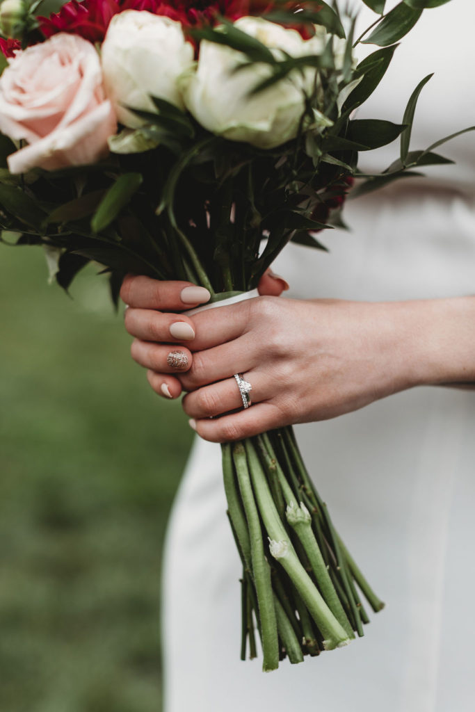 bride holding fall wedding flowers