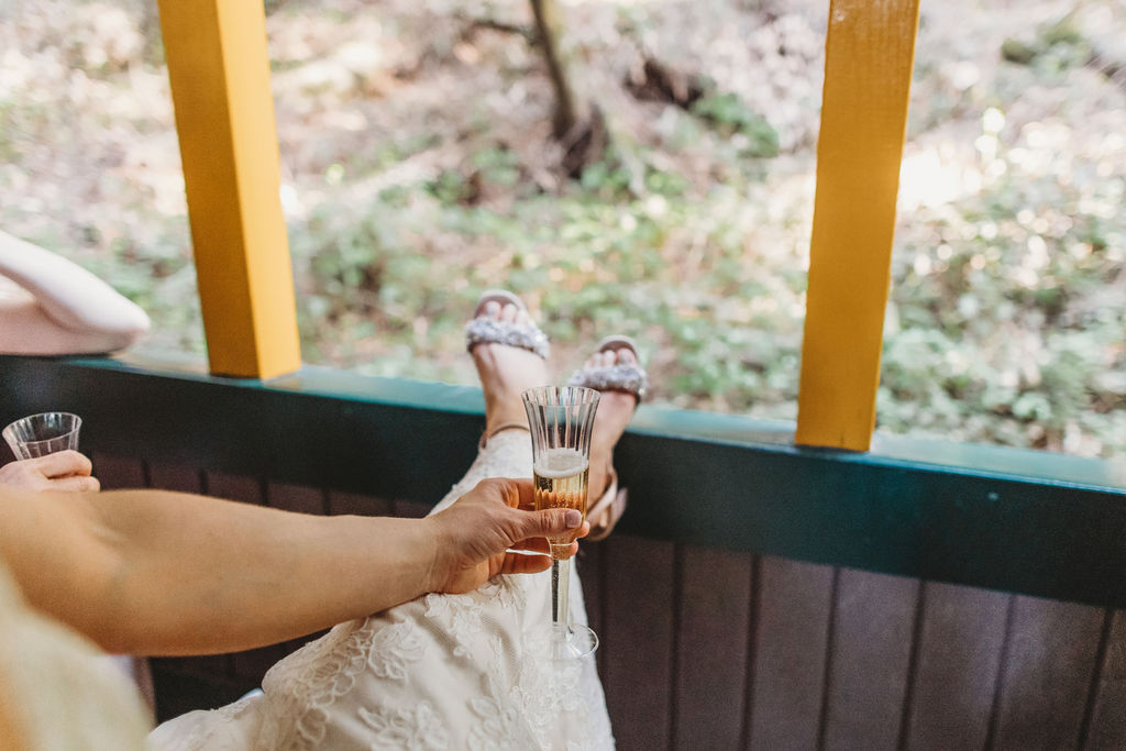 bride holding champagne after wedding ceremony