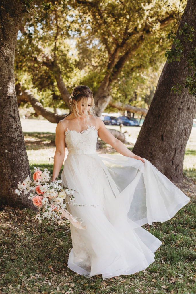 photos of bride holding wedding flowers in beautiful lace wedding dress