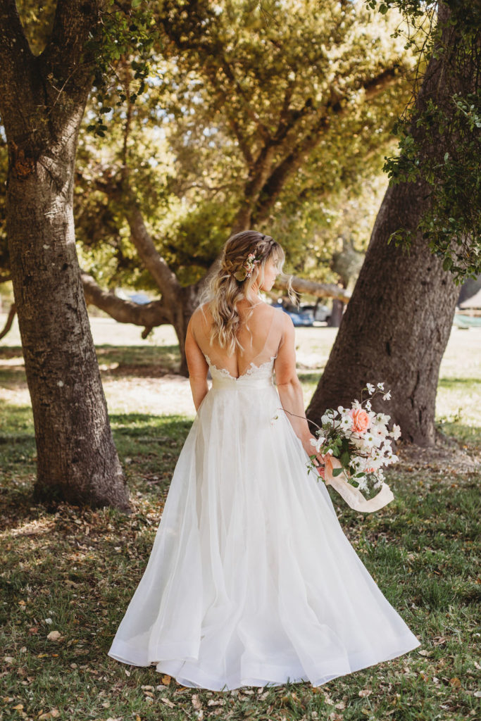 photos of bride holding wedding flowers in beautiful lace wedding dress