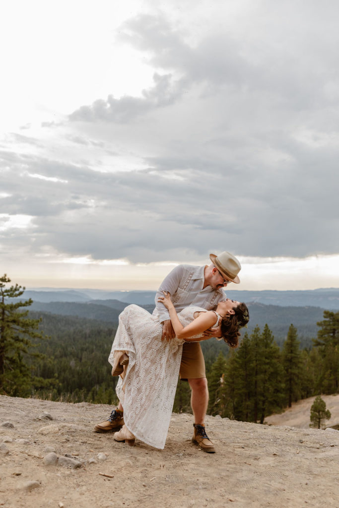 couple eloping on cliffside in the mountains