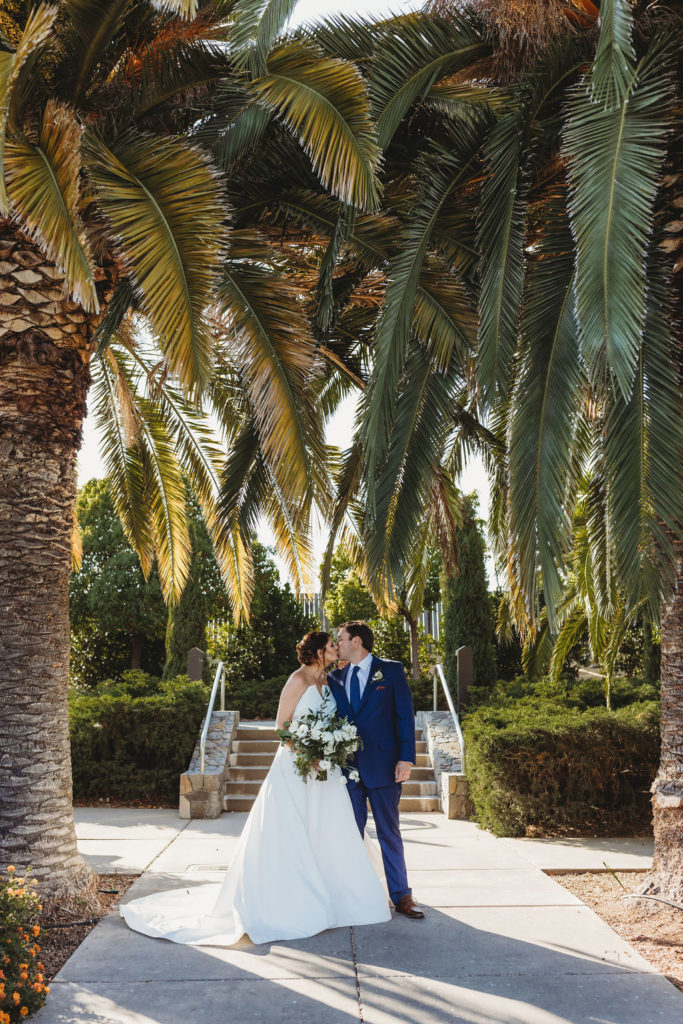 bride and groom photos in palm trees in napa