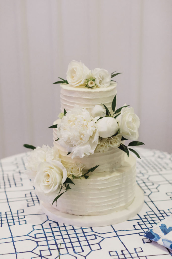 white wedding cake with white flowers