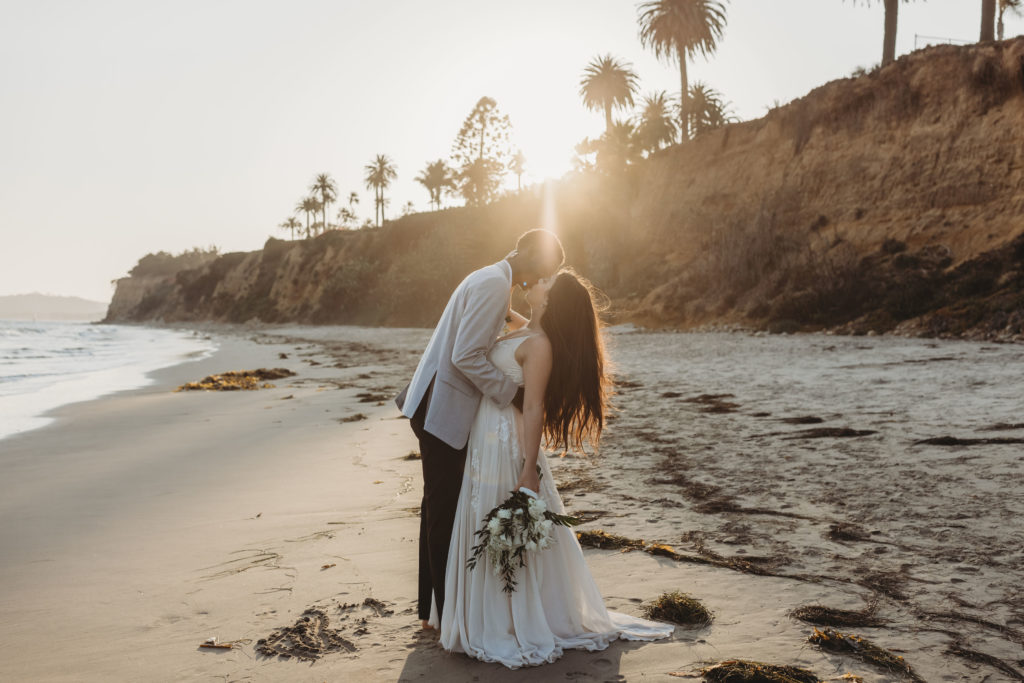couple kissing during elopement at beach