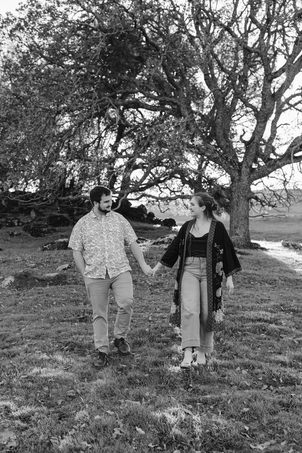 couple walking holding hands at engagement photoshoot
