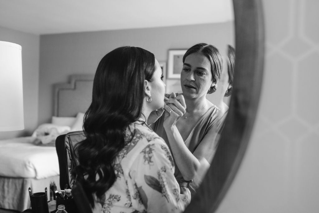 Bride getting lipstick on before wedding day