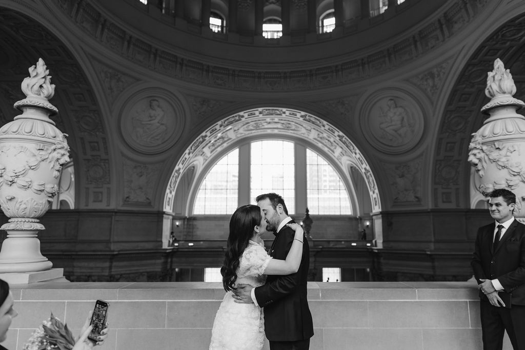bride and groom kissing during san francisco city hall wedding