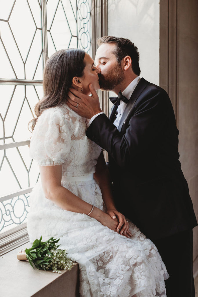 Couple posing for wedding photos after San Francisco City Hall Wedding
