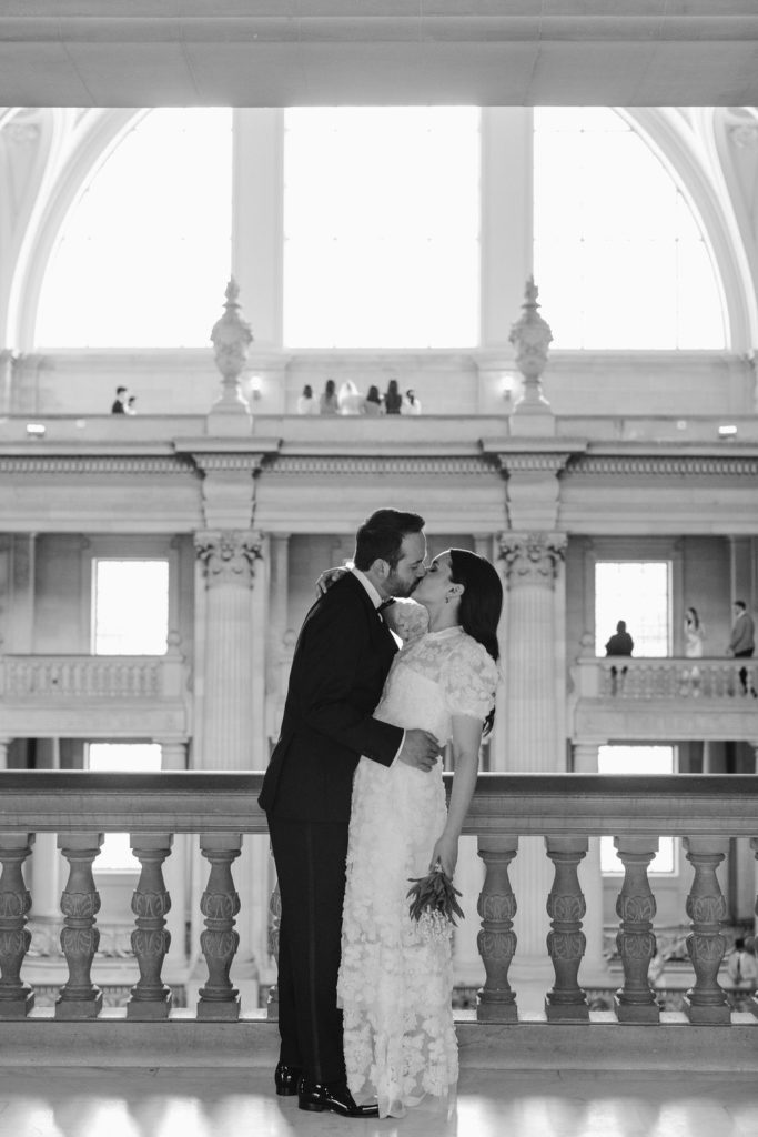 Bride and groom posing for wedding portrits after San Francisco City Hall Wedding