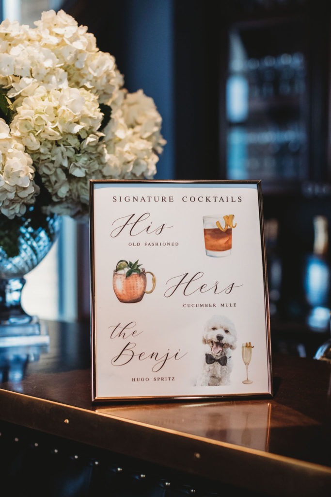 sign that has bride and grooms signature cocktails