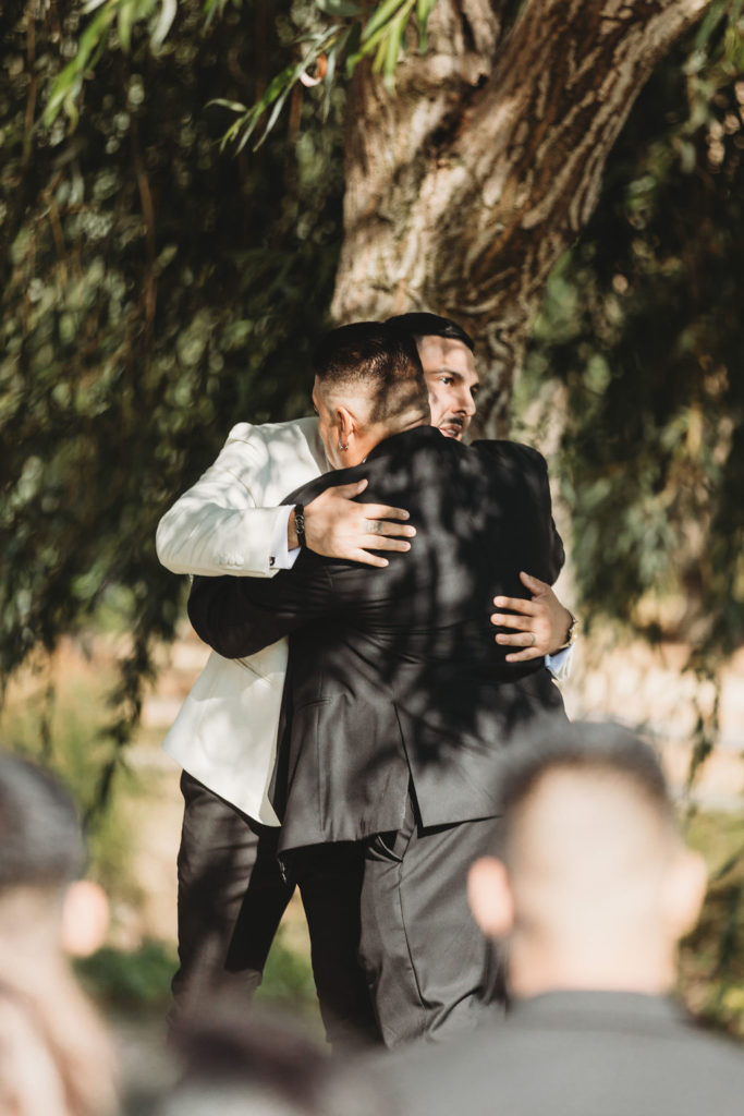 groom and father hugging