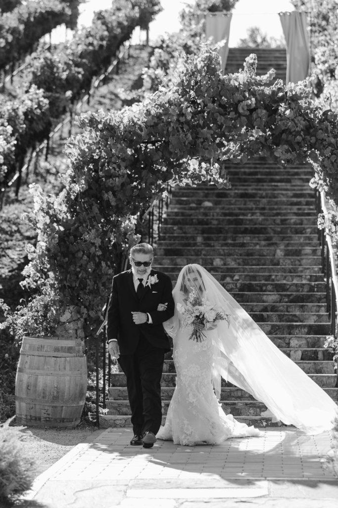 bride walking down the aisle with her father