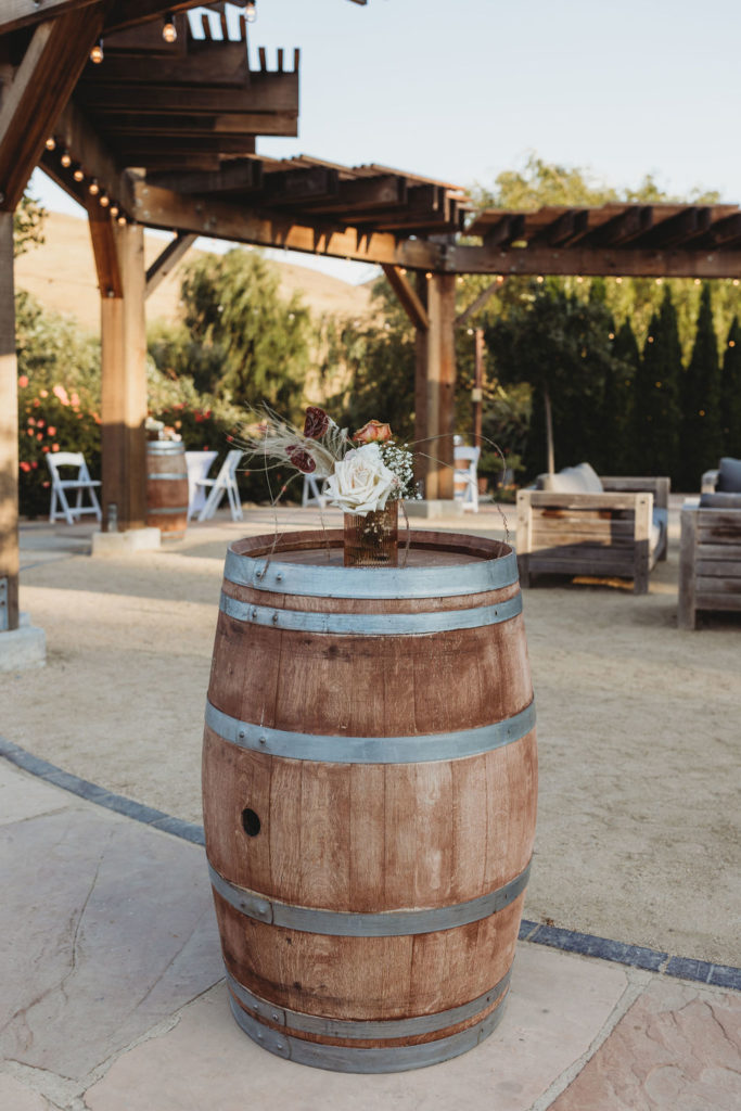 barrel with wedding flowers on top