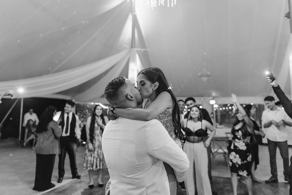 bride and groom kissing after wedding