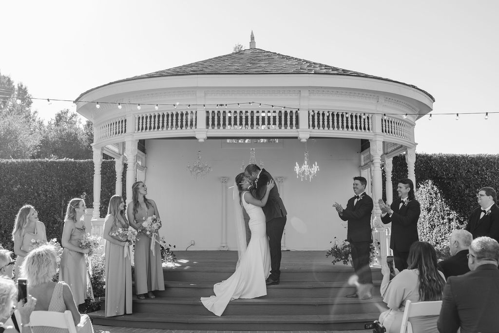 bride and groom kissing at the altar