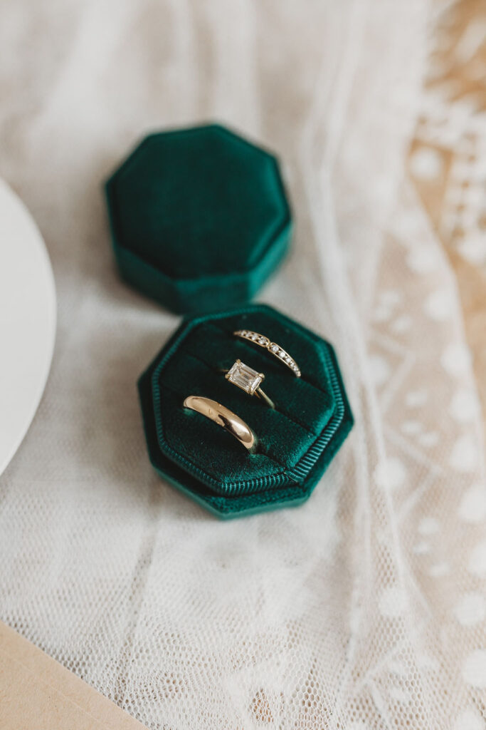 Wedding rings and band in emerald green box