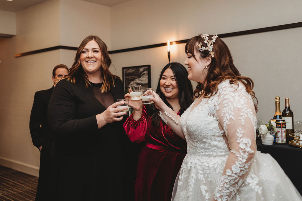 Bride taking shots with wedding guests