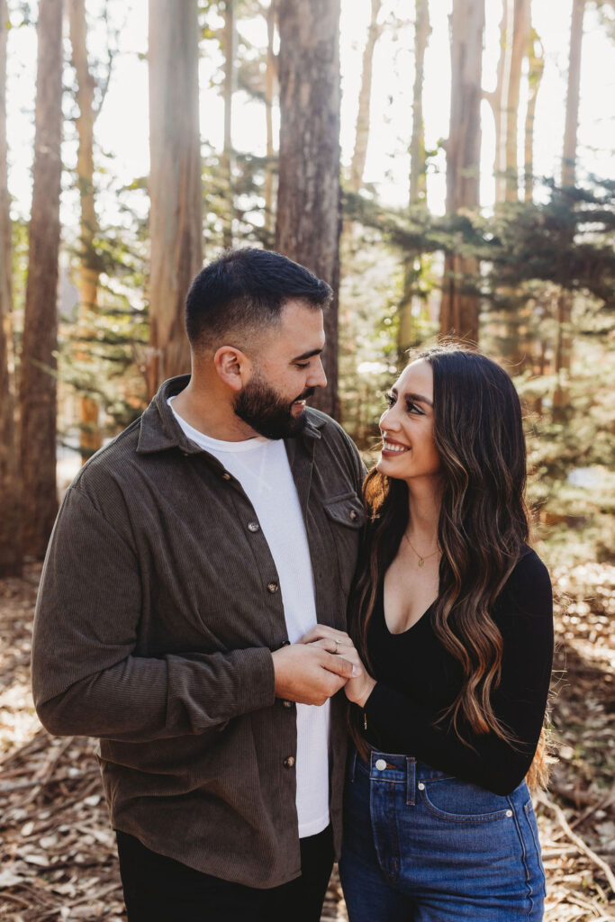 Couple posing for Lovers' Lane San Francisco forest engagement photos