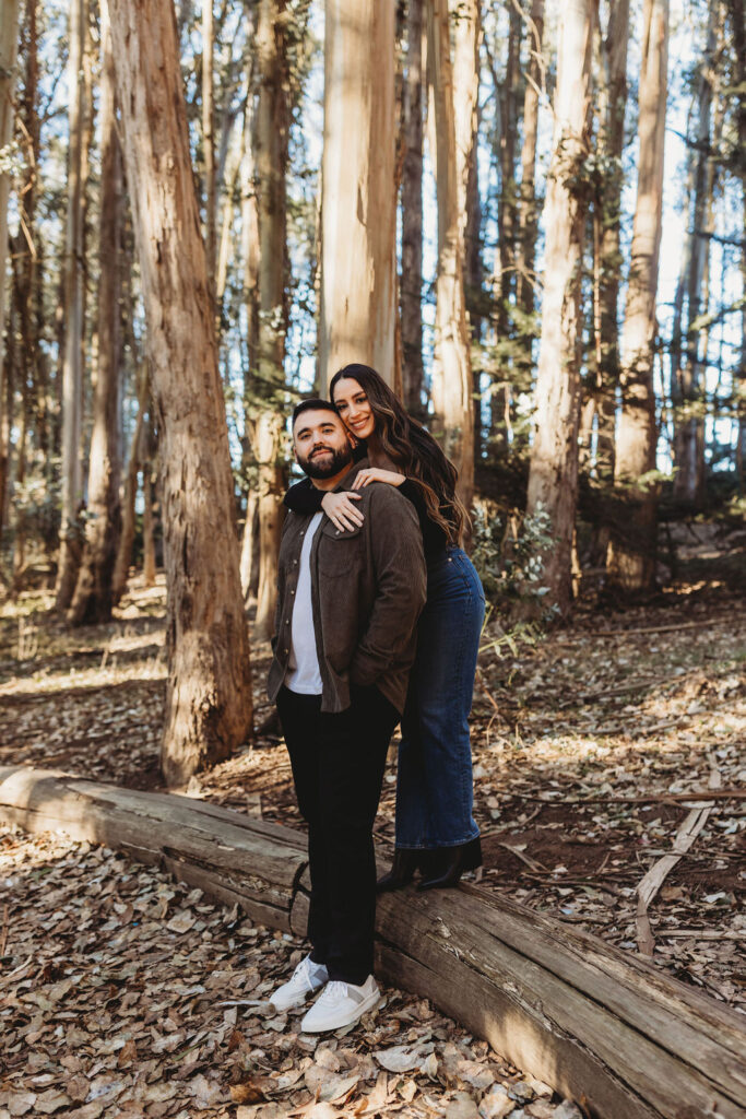 Couple posing for Lovers' Lane San Francisco forest engagement photos