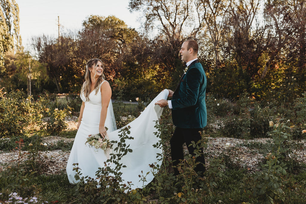 Bride and groom walk through secret garden